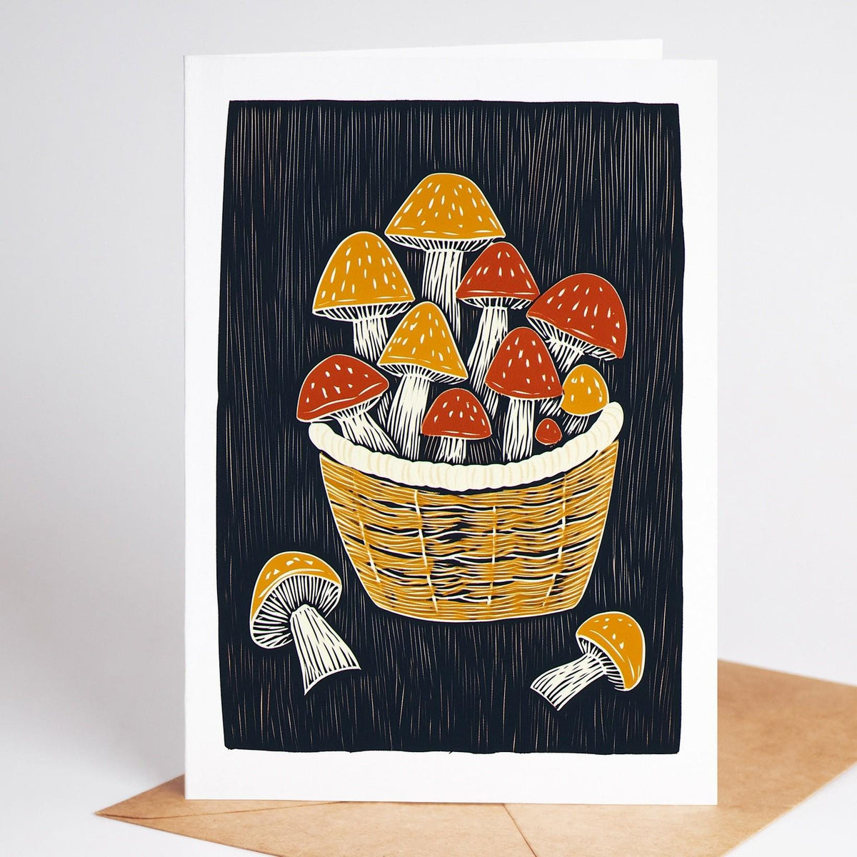 Mushroom card, a woven basket of foraged red and gold mushrooms on black