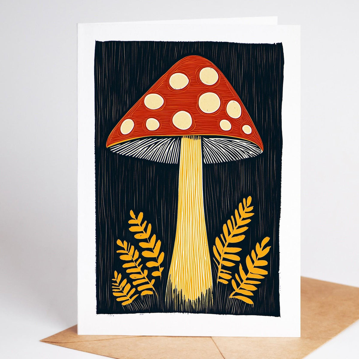 Mushroom card, a red-capped fly agaric with white spots between golden ferns