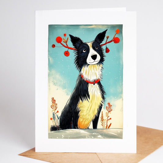 Border Collie Christmas card standing with its envelope, folk art dog in red reindeer antlers in the snow