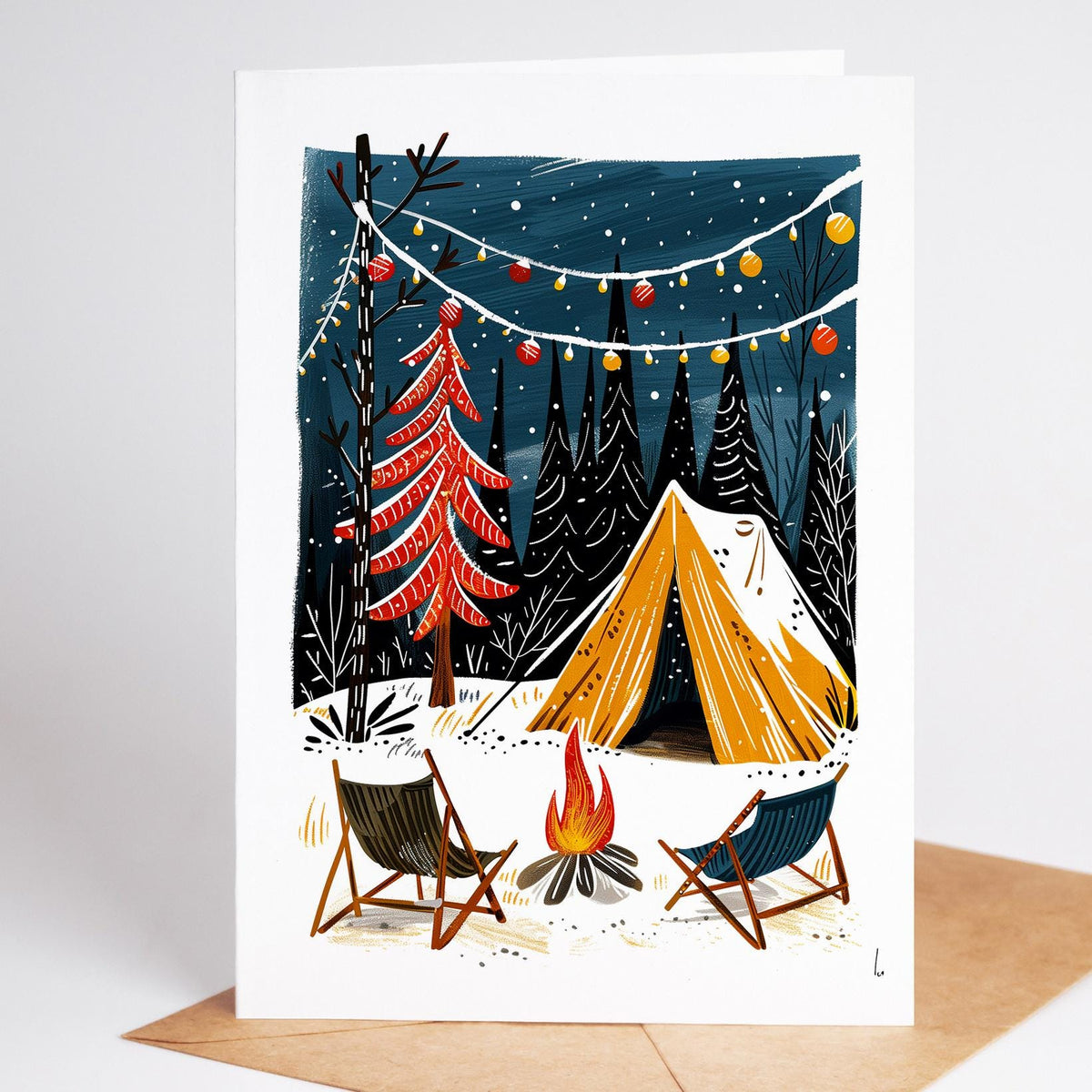 Camping Christmas card of empty camp chairs by a fire and a trimmed red tree
