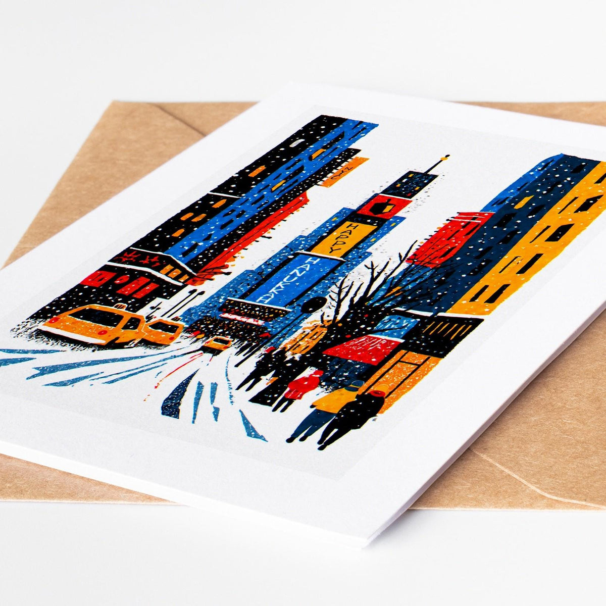New York Hanukkah card lying on a kraft envelope, folk art Times Square at night with a Happy Hanukkah billboard