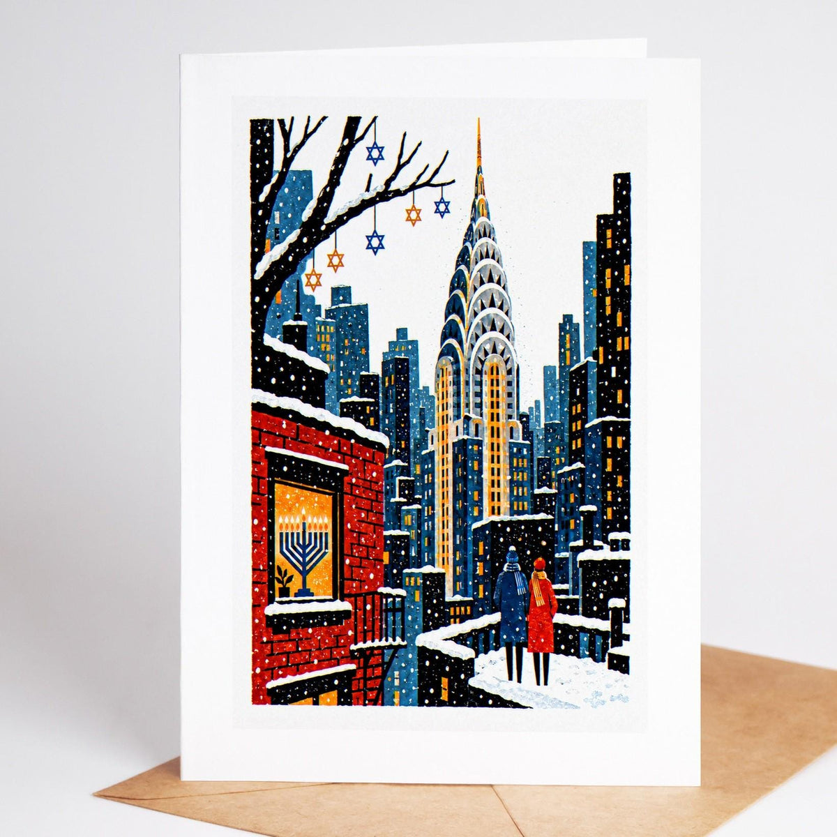 New York Hanukkah card standing upright, the Chrysler Building at night with a menorah in a brick window