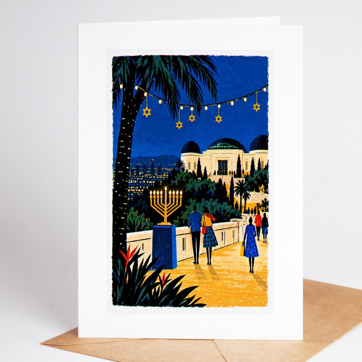 Los Angeles Hanukkah card standing with envelope, Griffith Observatory above the city lights with a lit menorah