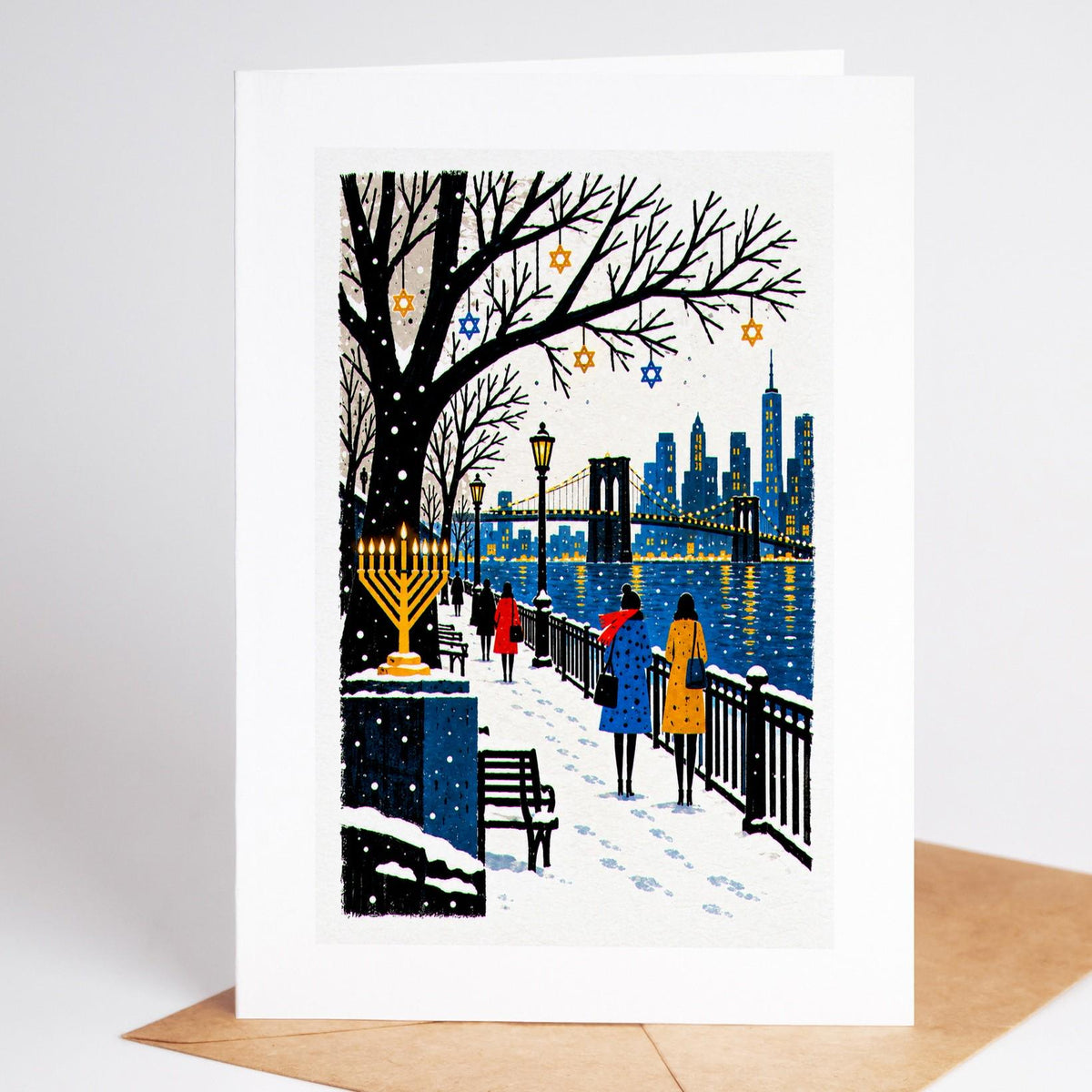 Brooklyn Hanukkah card standing upright, the Brooklyn Heights promenade in the snow, a lit menorah above the Manhattan s