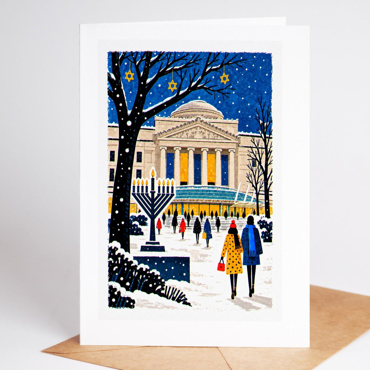 Brooklyn Hanukkah card standing upright, the Brooklyn Museum steps in the snow with a large lit menorah