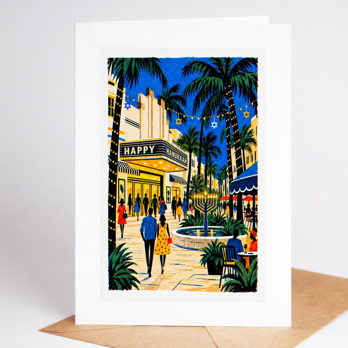 South Florida Hanukkah card standing upright, Lincoln Road under a Happy Hanukkah marquee with a menorah by the fountain