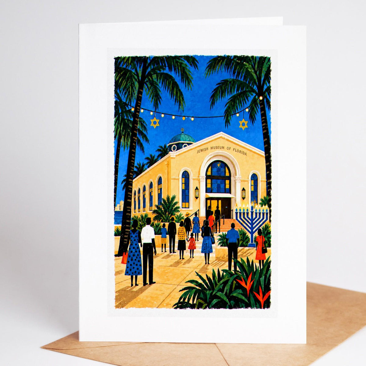 South Florida Hanukkah card standing with envelope, the Jewish Museum of Florida with a lit menorah outside its steps