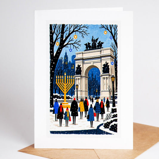 Brooklyn Hanukkah card standing upright, the Grand Army Plaza arch with a tall lit menorah beside it
