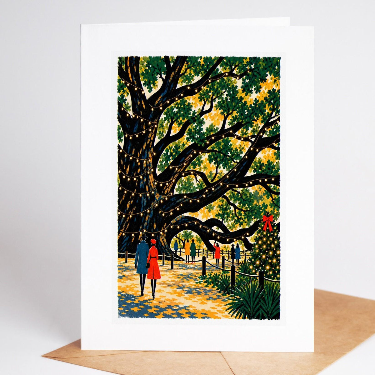 Charleston Christmas card standing upright, the Angel Oak's spreading branches hung with lights