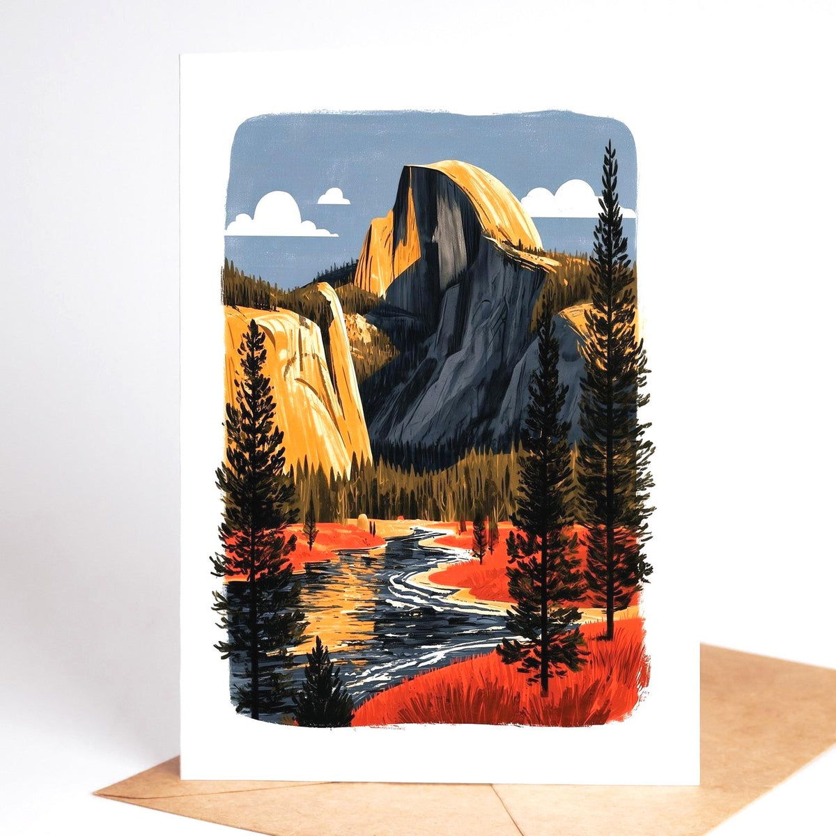 National park card standing on a kraft envelope, Half Dome and a waterfall at Yosemite above an autumn river