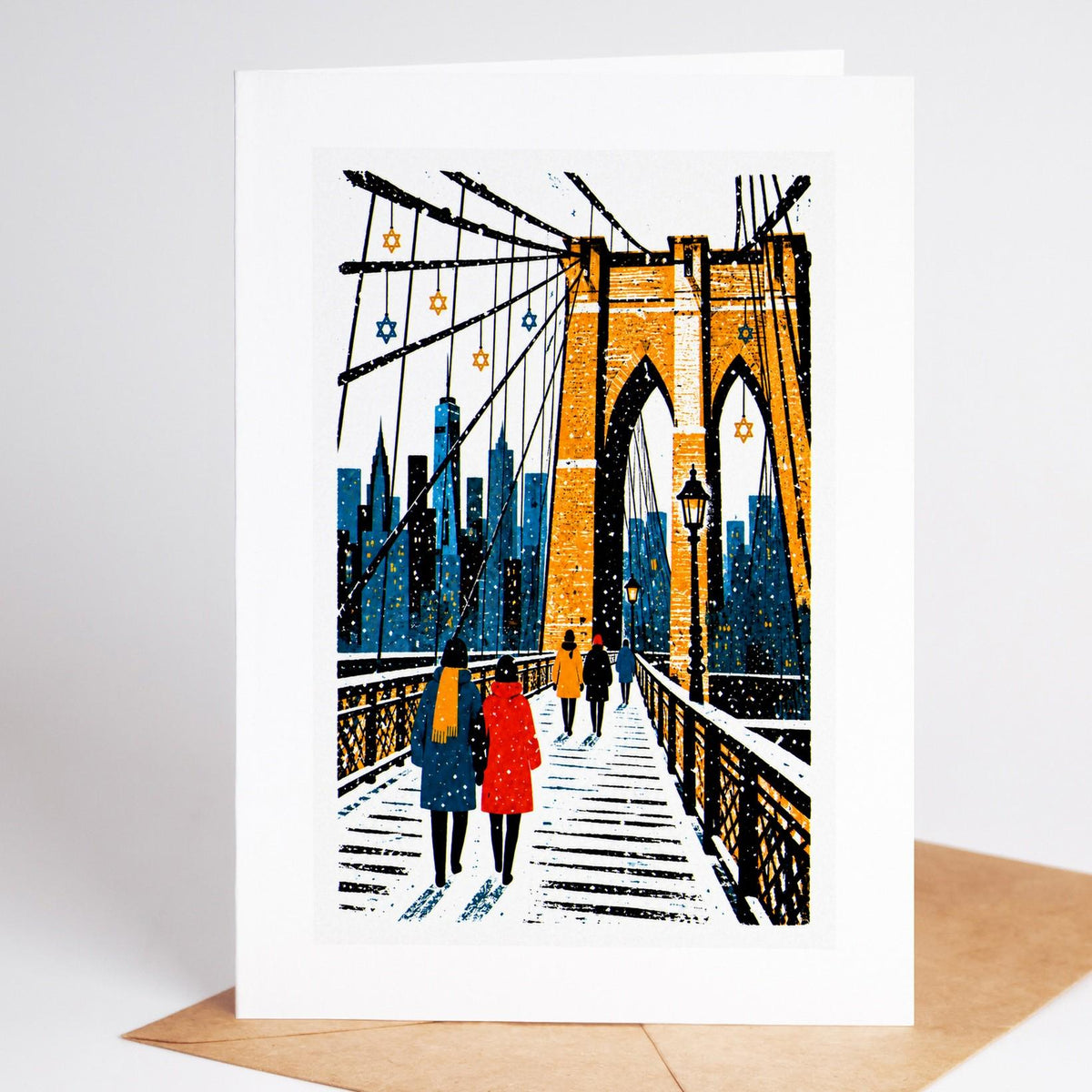 New York Hanukkah card standing upright, the Brooklyn Bridge in falling snow hung with Stars of David