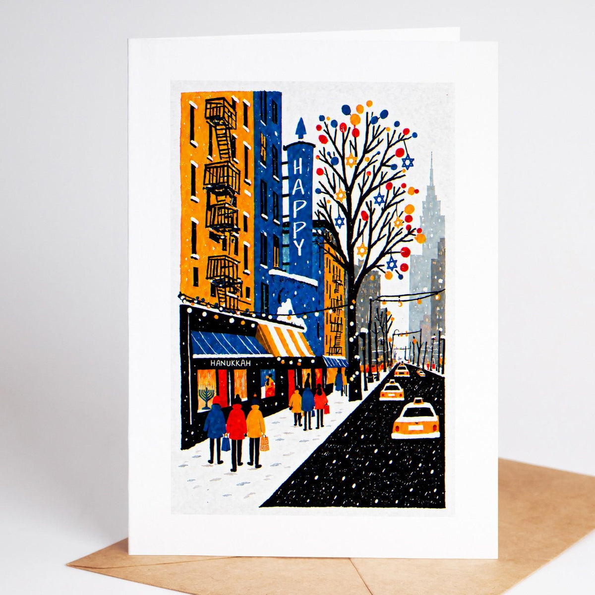 New York Hanukkah card standing with envelope, tenement fire escapes strung with lights above a Hanukkah awning
