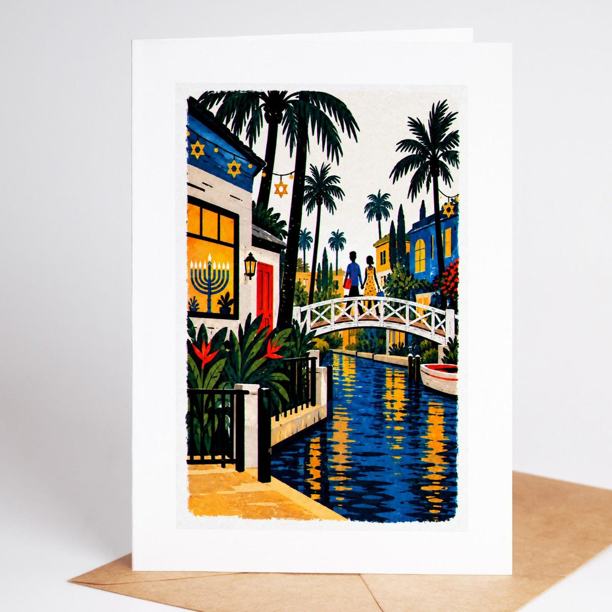 Los Angeles Hanukkah card standing with envelope, the Venice canals at dusk with a lit menorah in a canal-house window