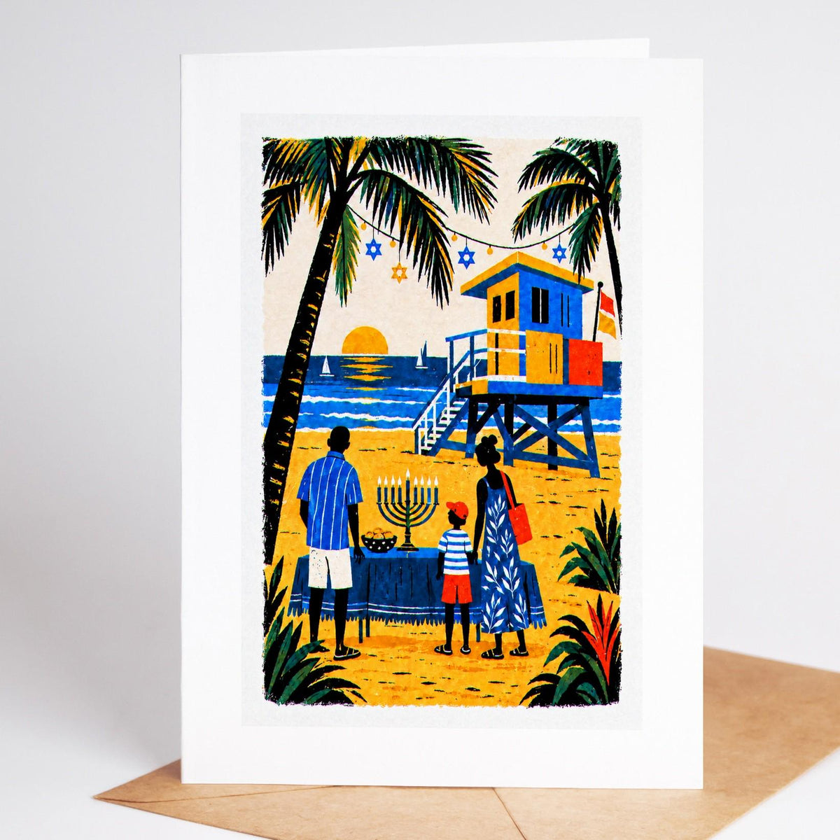 South Florida Hanukkah card standing upright, a family at a South Beach lifeguard stand lighting a menorah at sunset