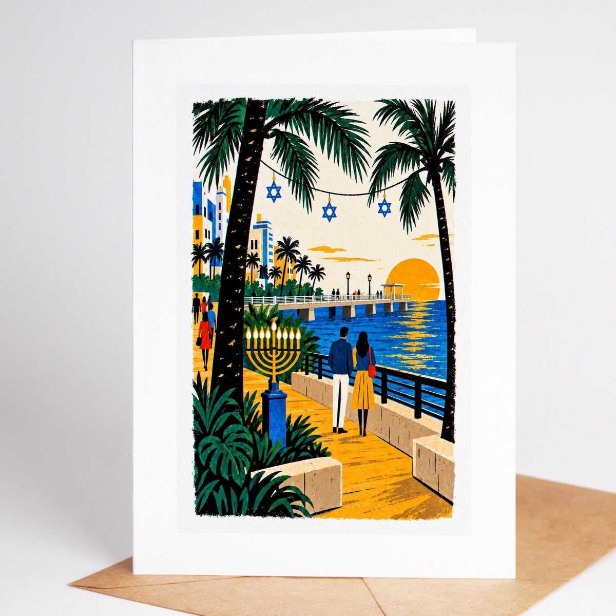 South Florida Hanukkah card standing with envelope, the South Pointe pier at sunset with a lit menorah on the promenade