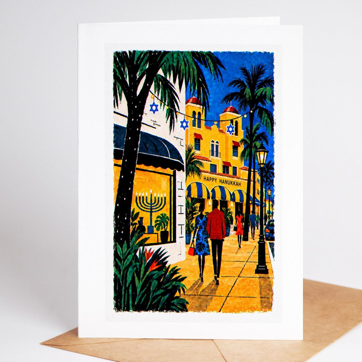 South Florida Hanukkah card standing upright, a Delray Beach street with a Happy Hanukkah awning and a lit menorah
