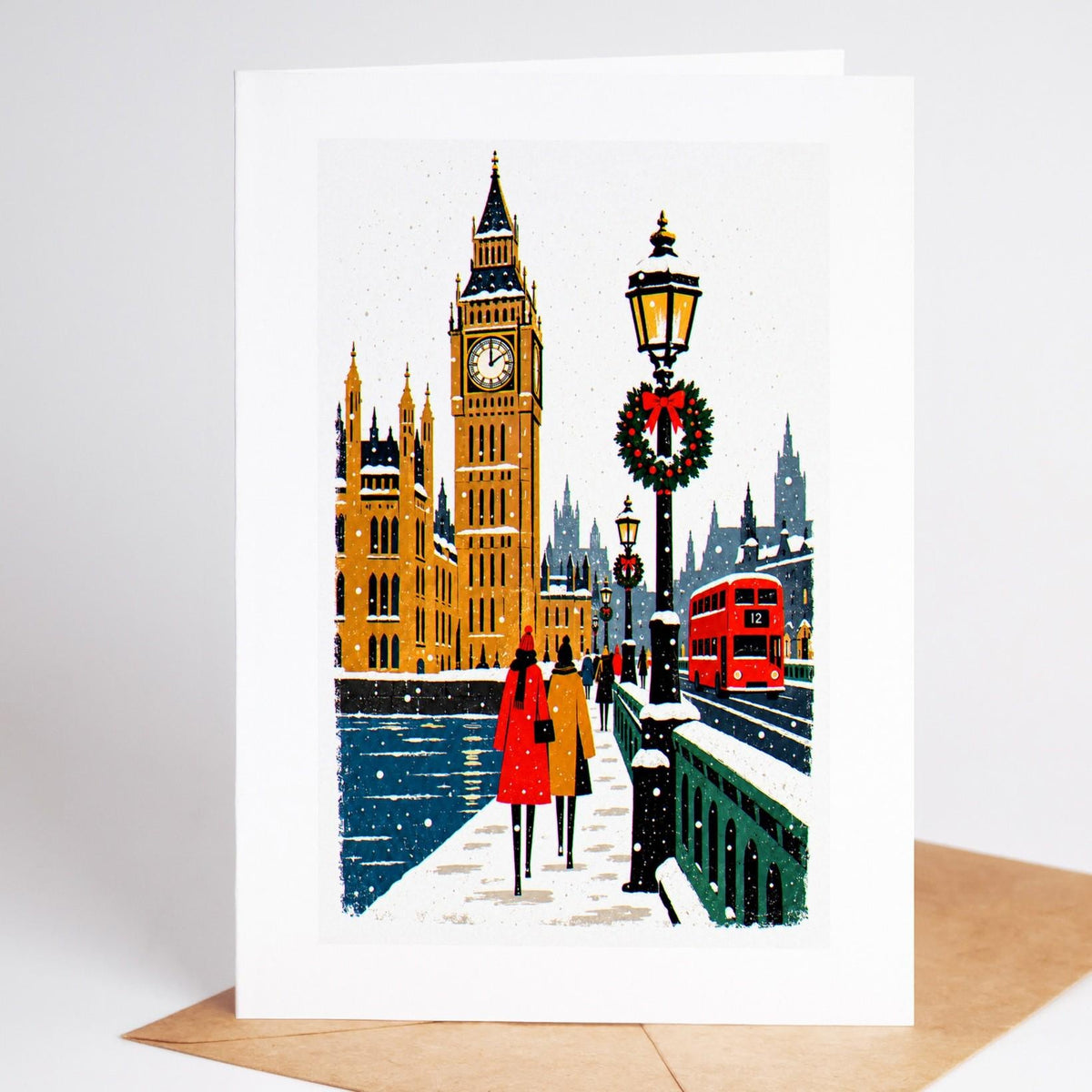London Christmas card standing with envelope, Big Ben and the Houses of Parliament in the snow with a red double decker 