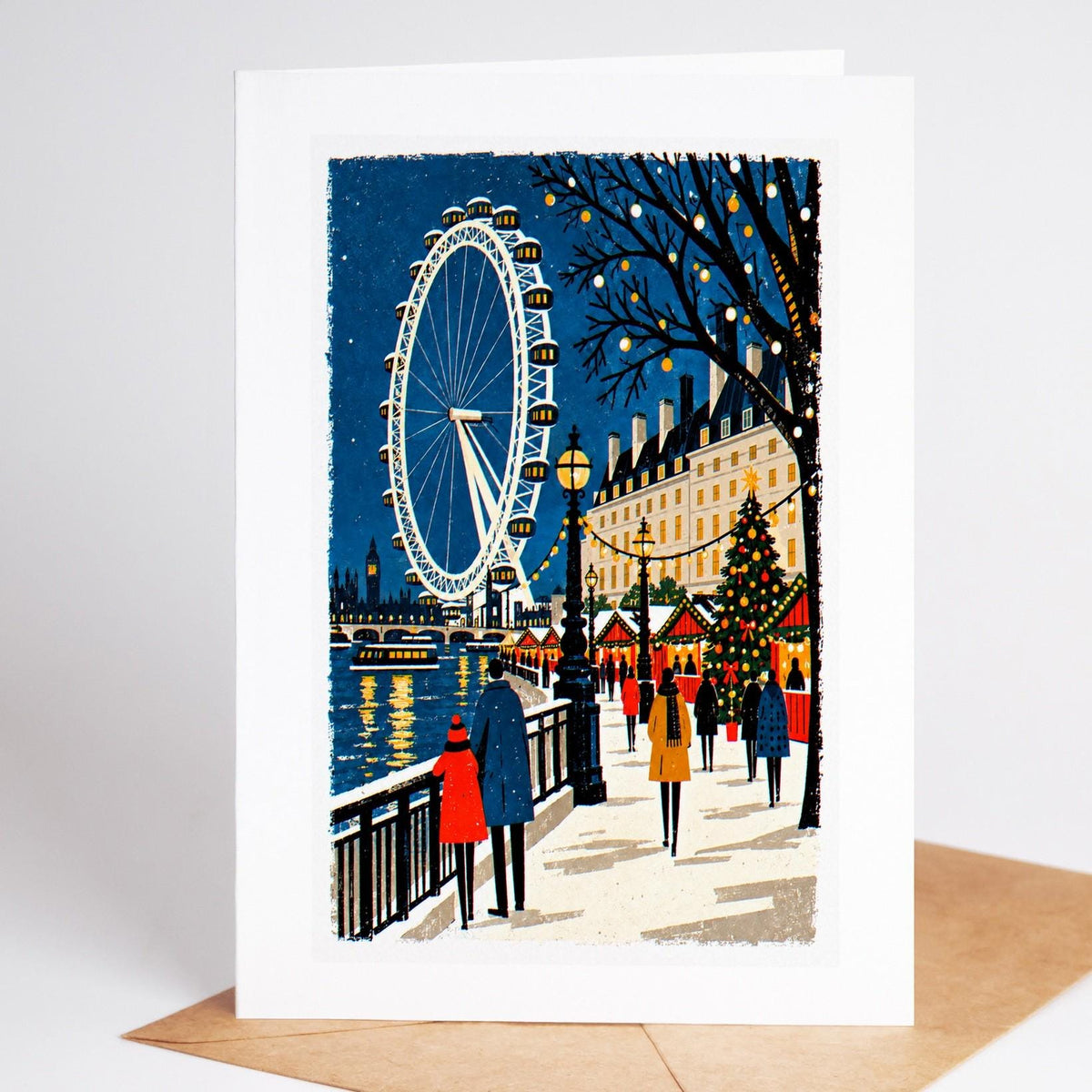 London Christmas card standing with envelope, the London Eye turning above the Thames in the snow