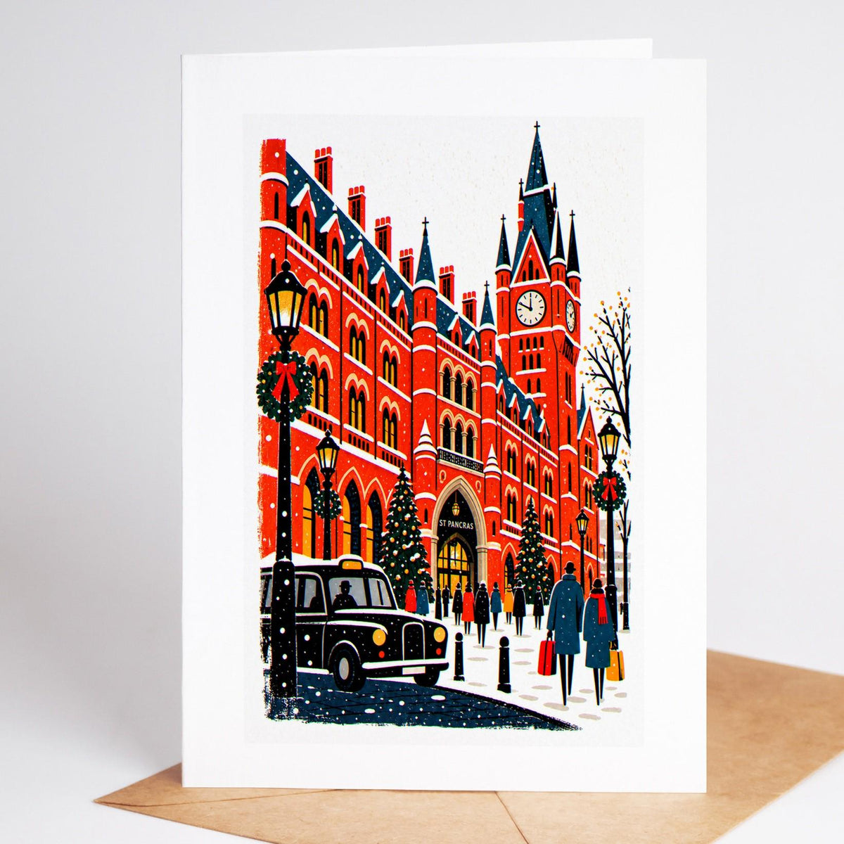 London Christmas card standing upright, the St Pancras station clock and its Christmas tree under the trainshed