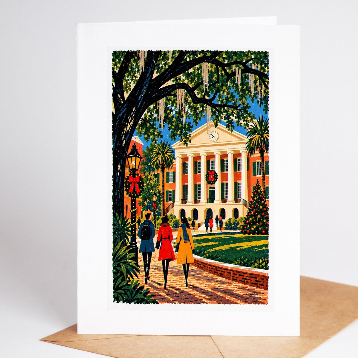Charleston Christmas card standing upright, the live oaks and Spanish moss of Cistern Yard strung with lights