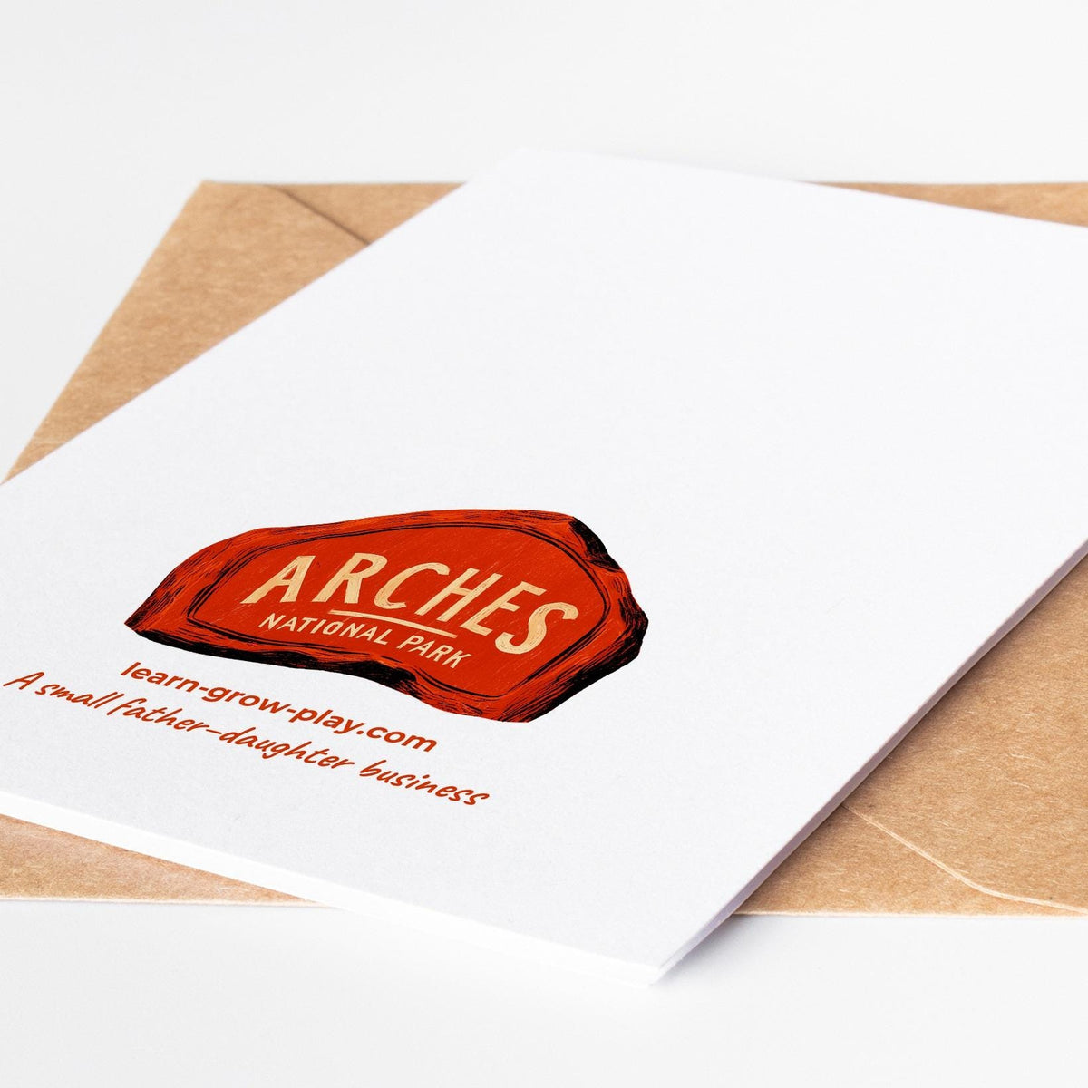 Back of a national park card with the Arches park sign, learn-grow-play.com and a small father-daughter business