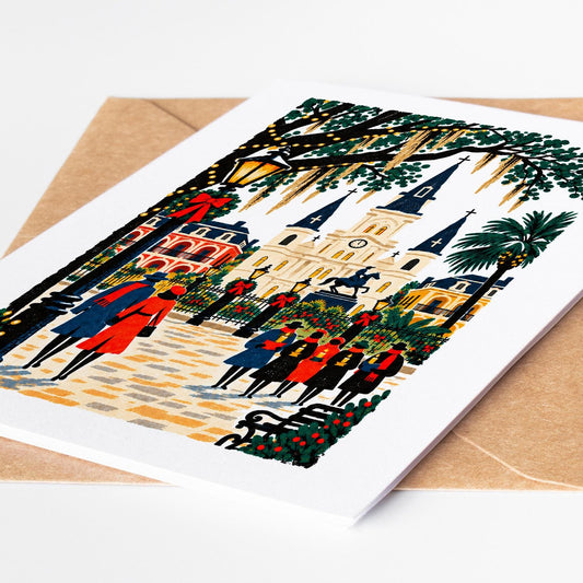 New Orleans Christmas card lying on a kraft envelope, folk art Jackson Square and St Louis Cathedral decked for the holi