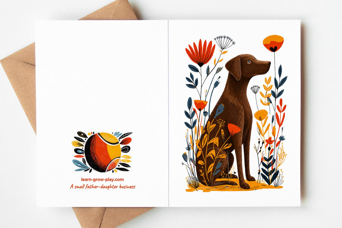 Chocolate Lab card opened flat on a kraft envelope, showing the front and the tennis ball logo on the back