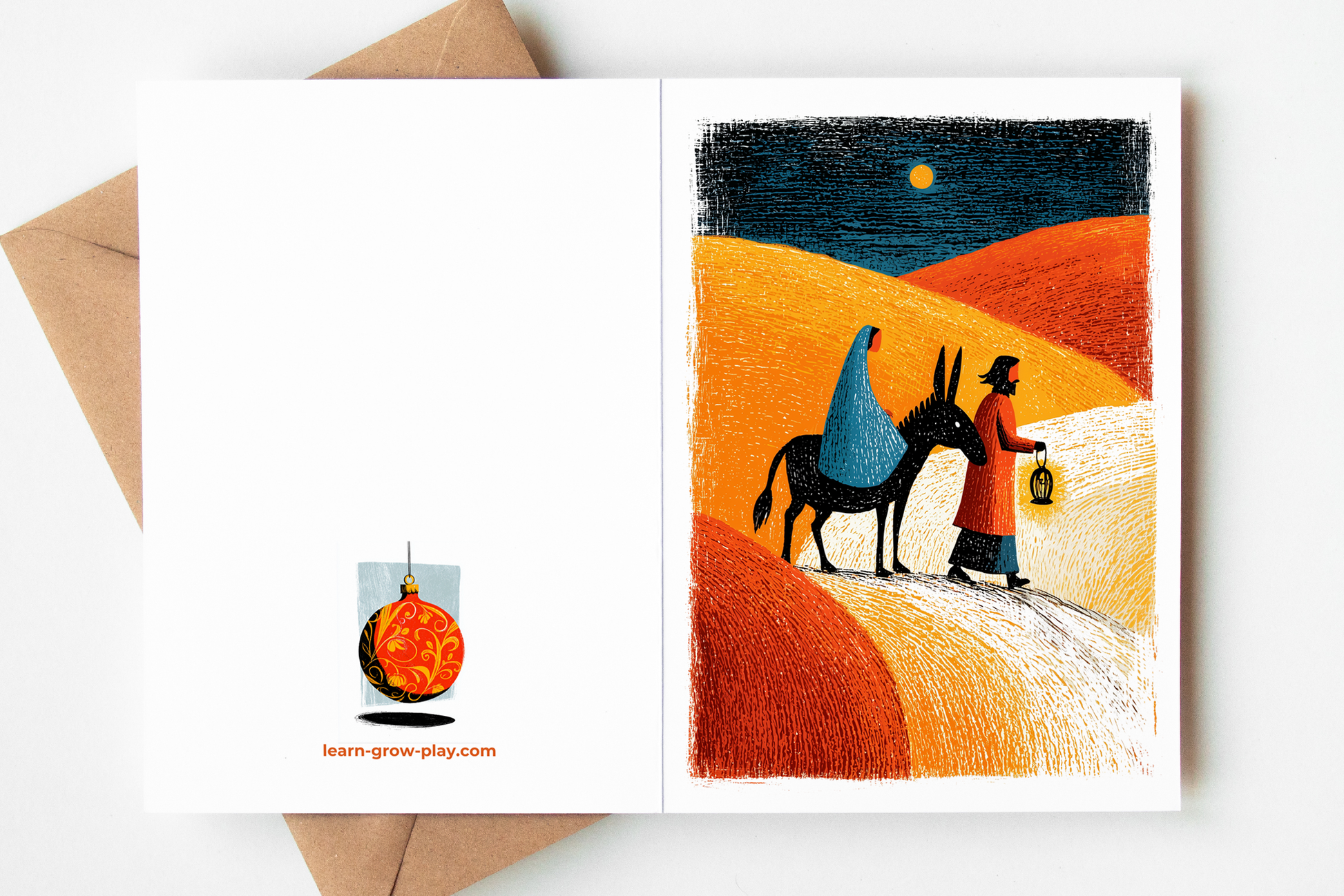 Full Nativity Christmas card showing both the back and front design — Mary and Joseph traveling by donkey through golden desert hills on the right, with a red ornament illustration and Learn Grow Play branding on the back cover.